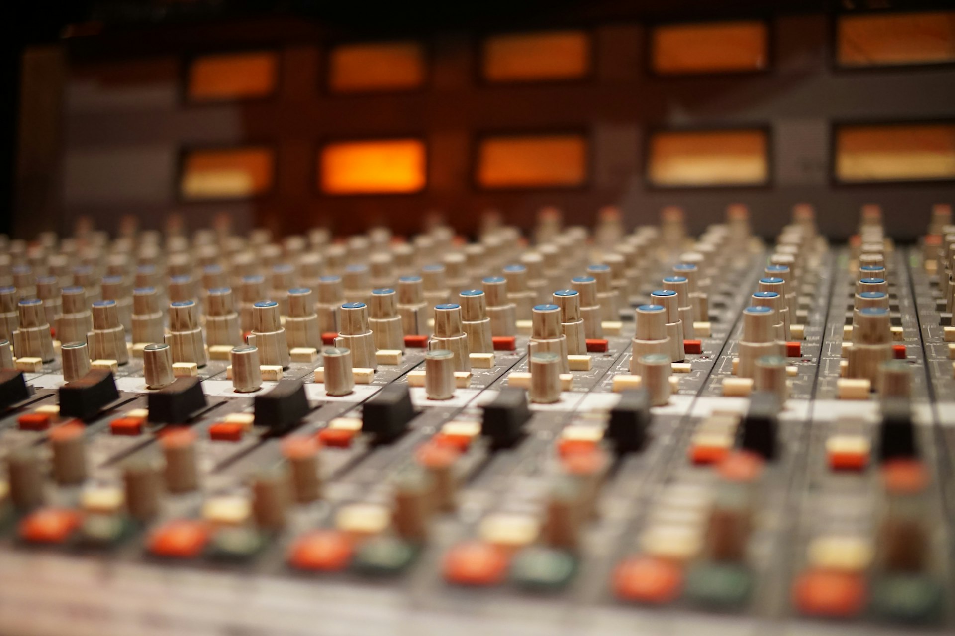a close up of a sound board with many knobs